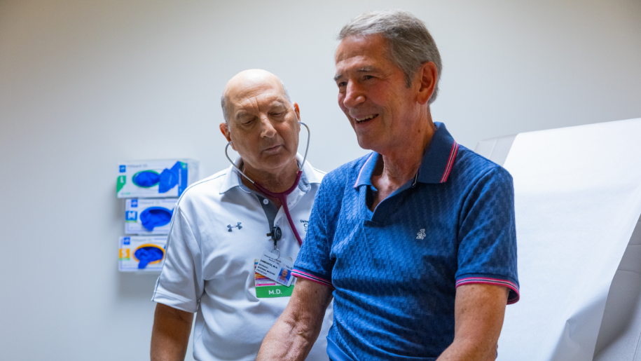 A medical provider shows a patient a medical device. 