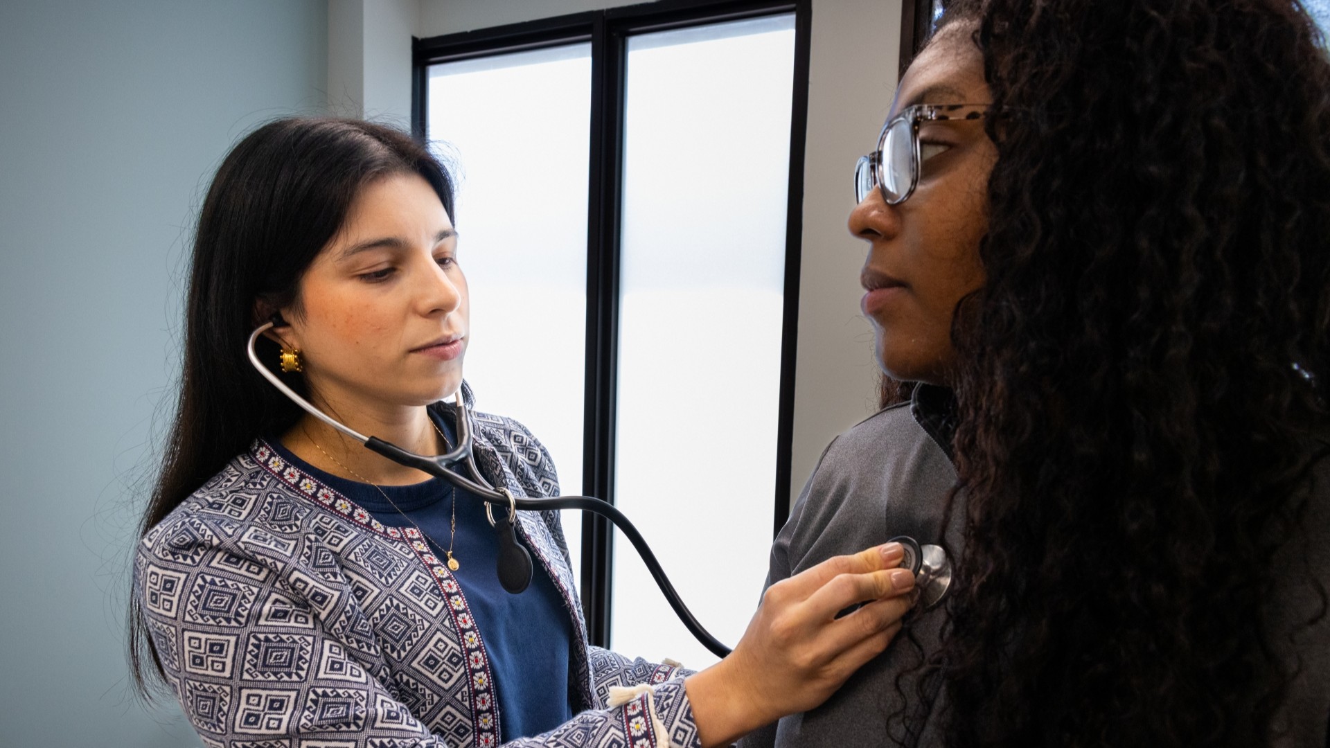 Medical provider examines a patient.