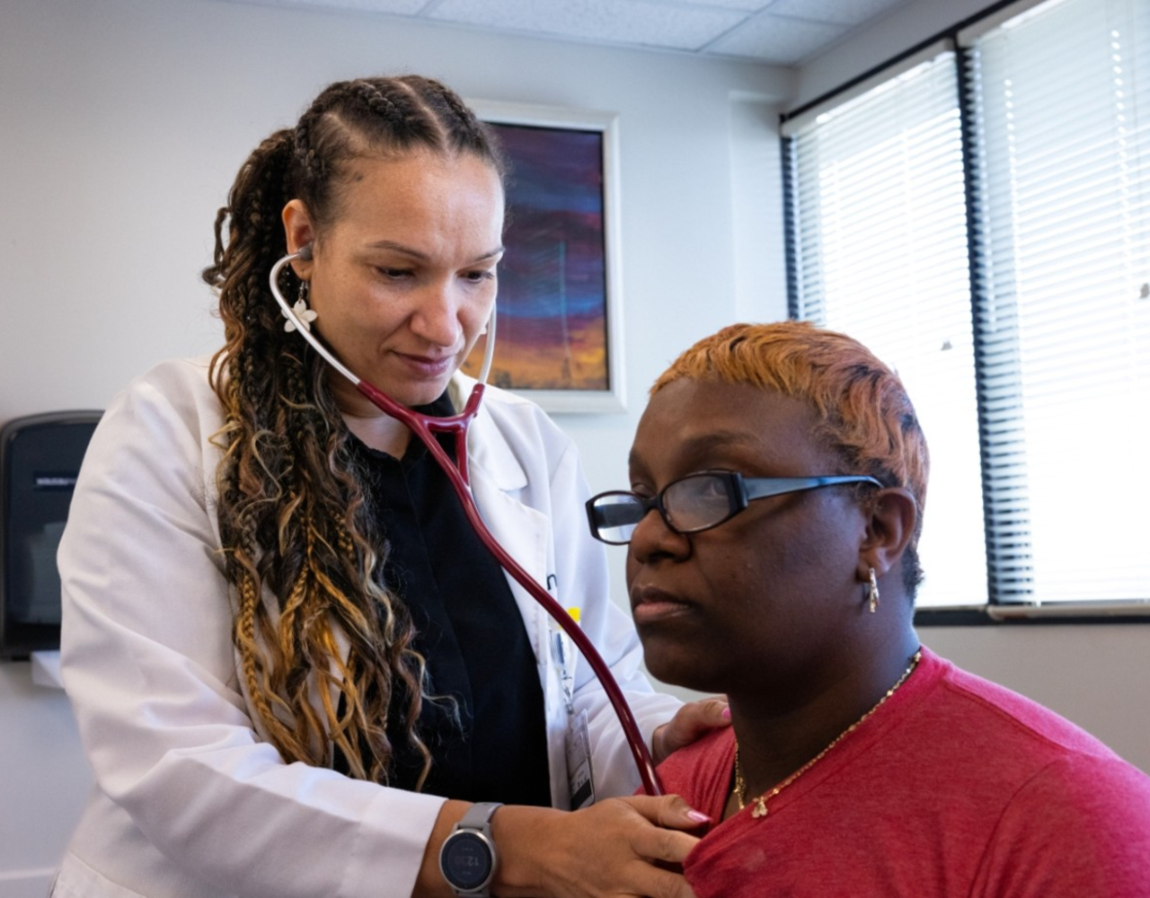 A medical provider examines a patient. 