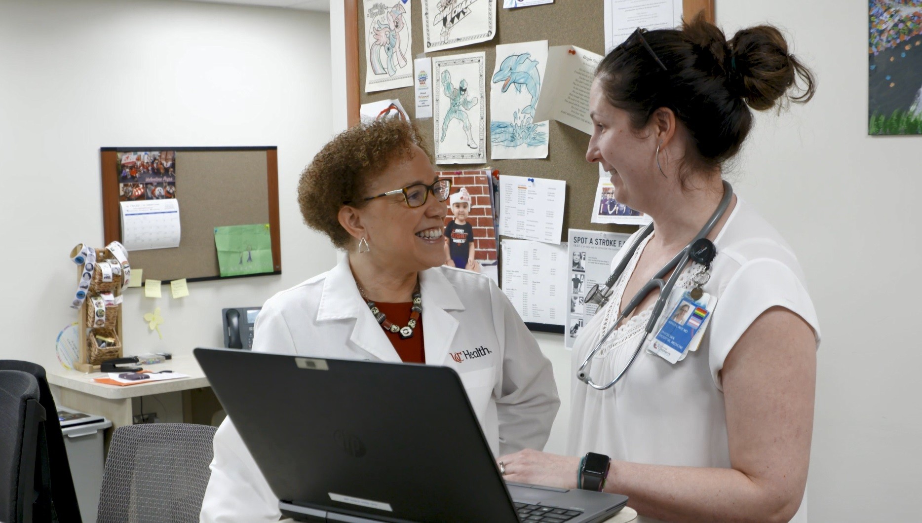 Two medical providers talk. 