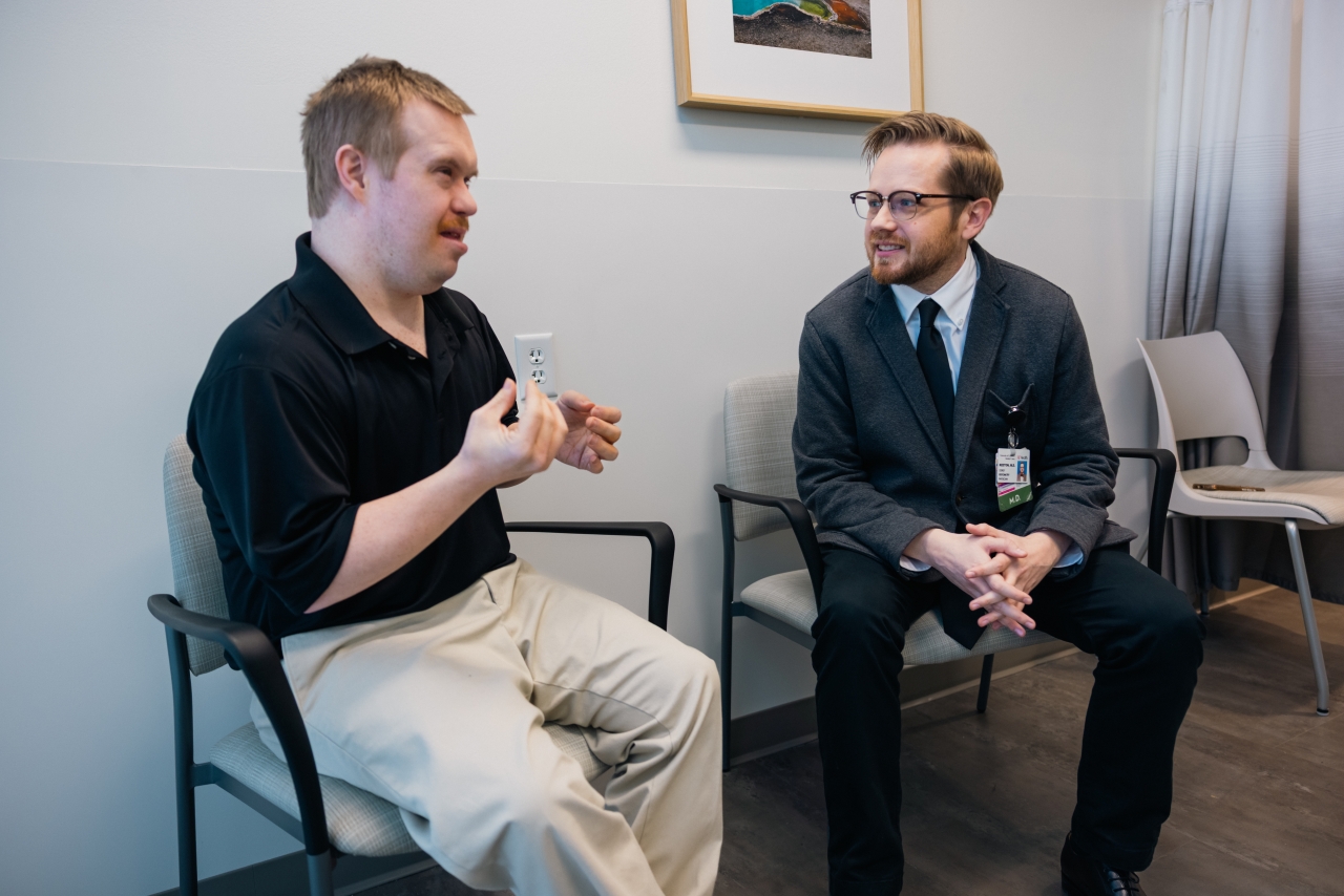 A primary care physician examines a patient. 