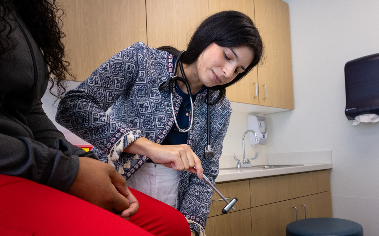 Primary care physician examines a patient.