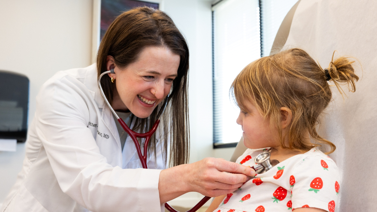UC Health Pediatrician examines a young patient with a stethoscope