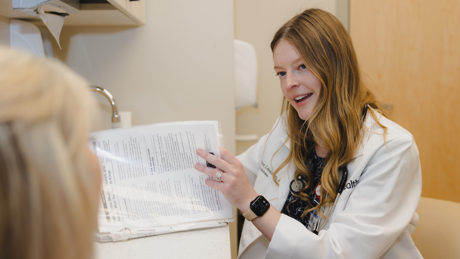 A medical provider smiles at a patient. 