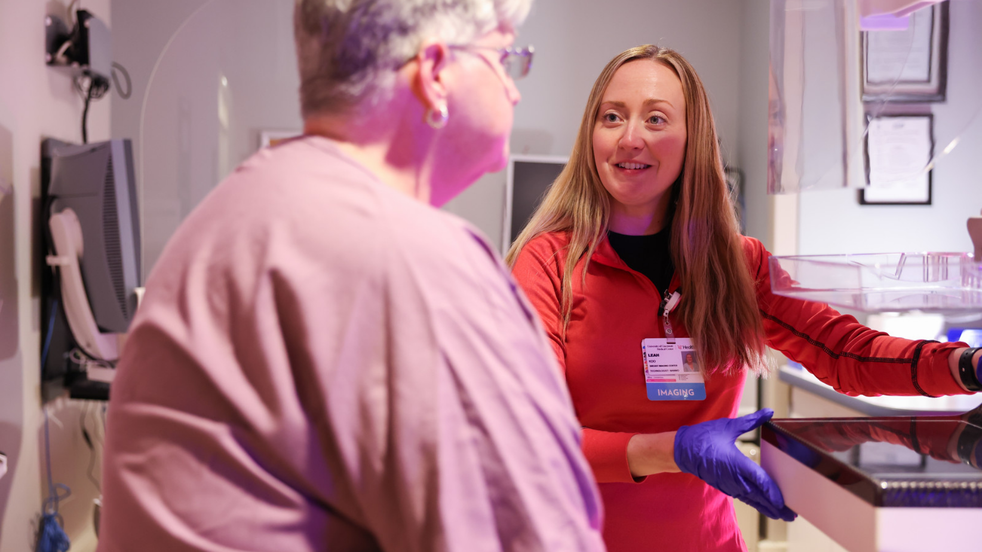 Imaging technician assists a patient during a mammogram at UC Health in Cincinnati