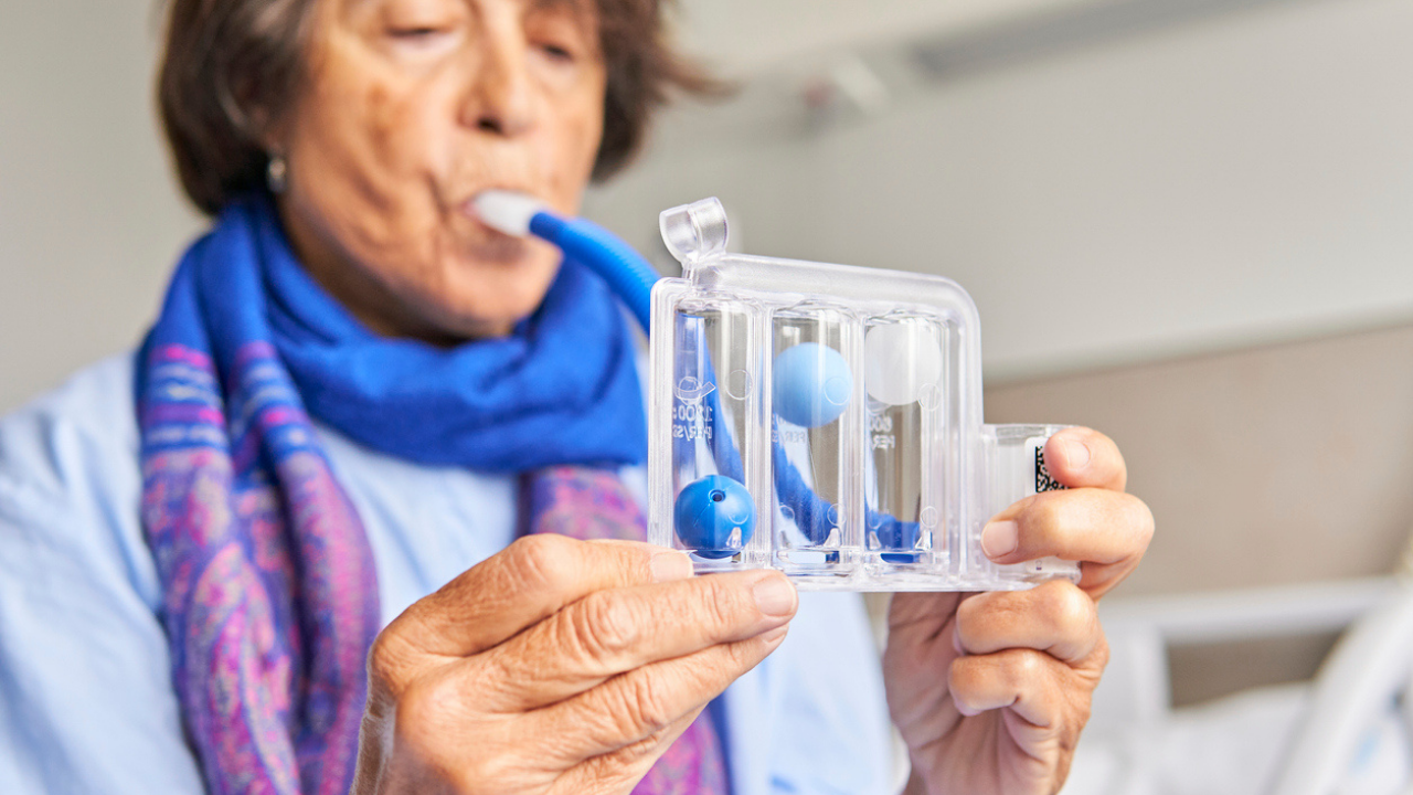 Woman uses a spirometer 