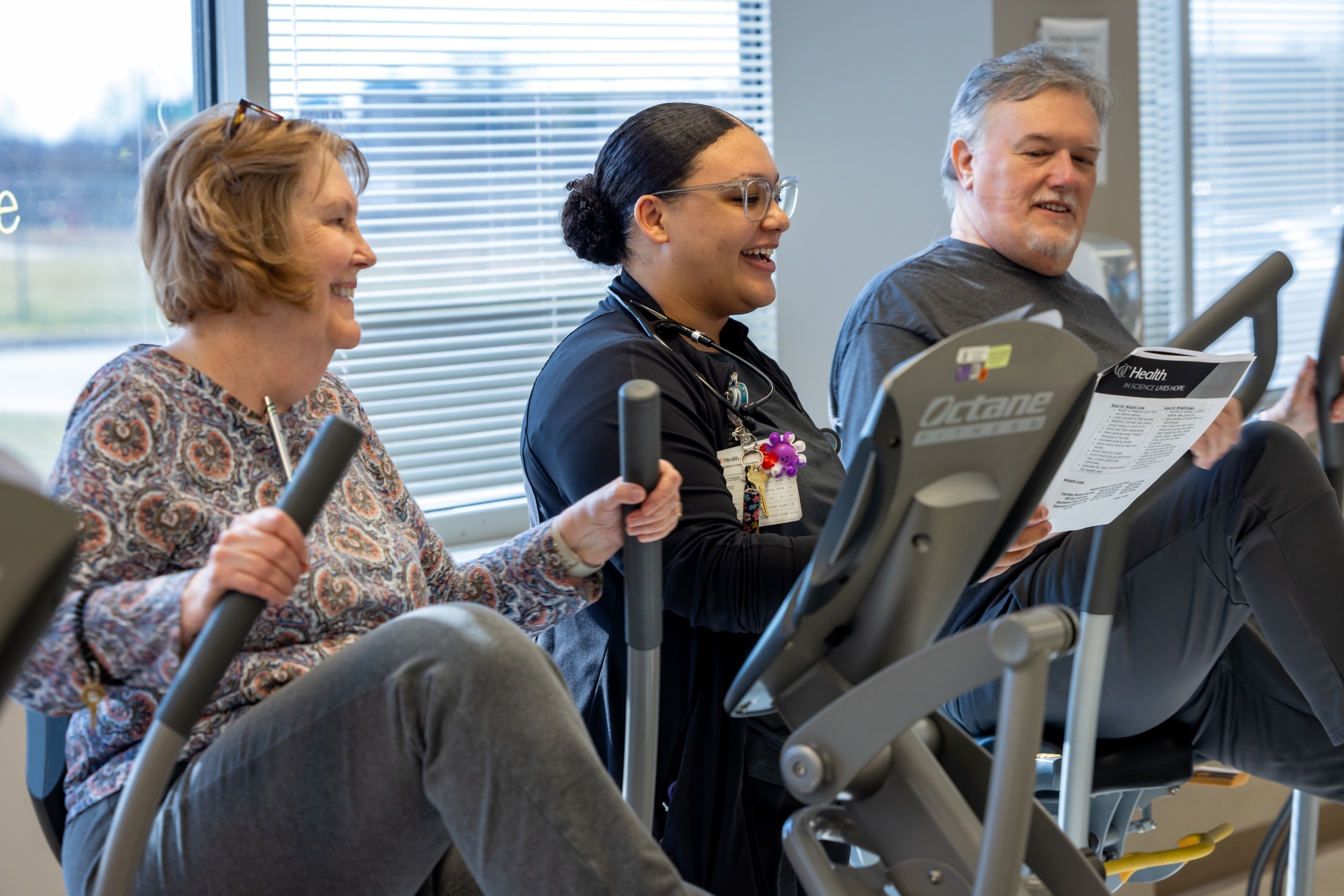 Patients exercise with physcial therapist during a cardiac rehab therapy session at UC Health in Cincinnati, Ohio 