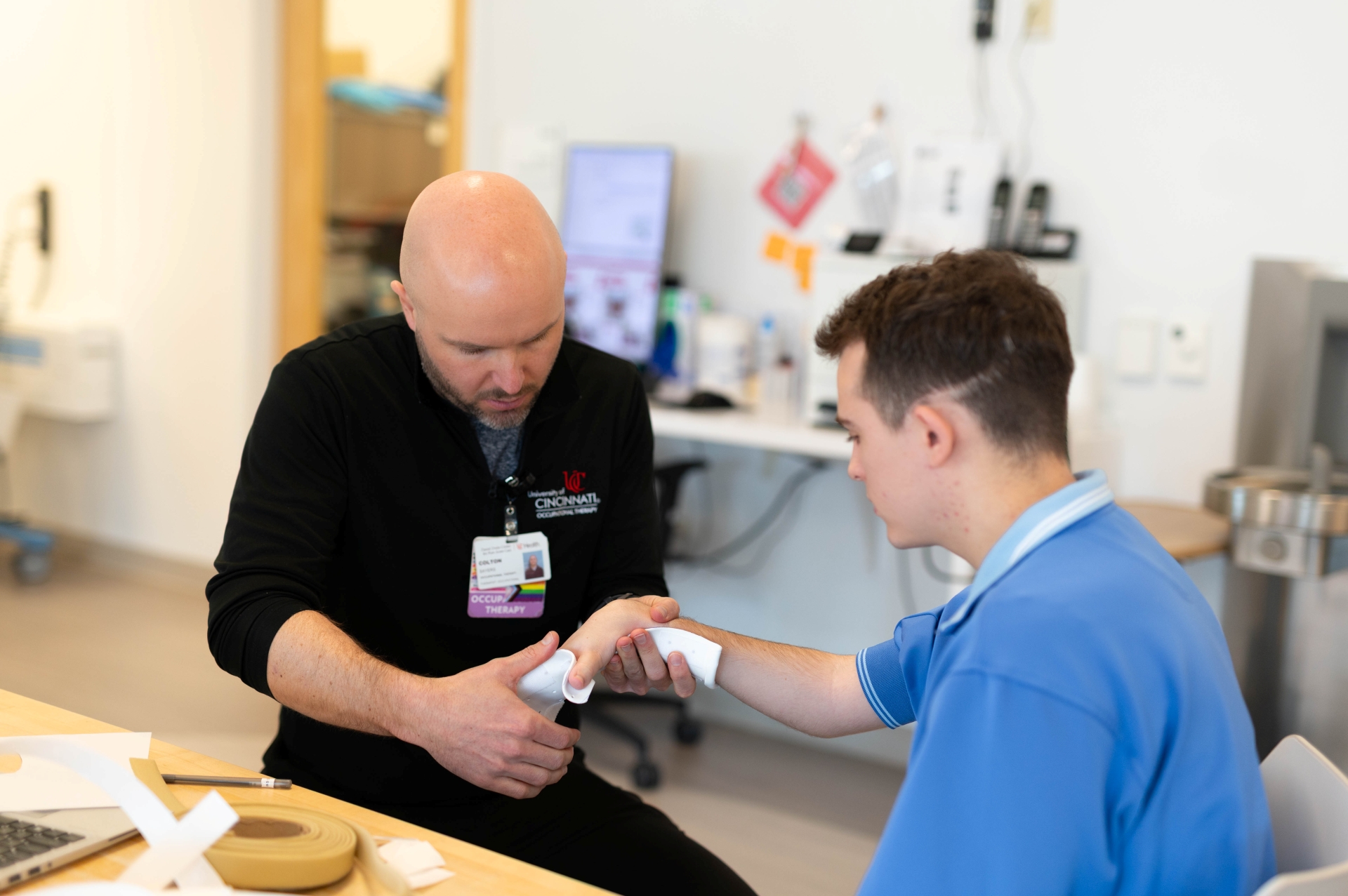 Therapist working with a patient's hand. 
