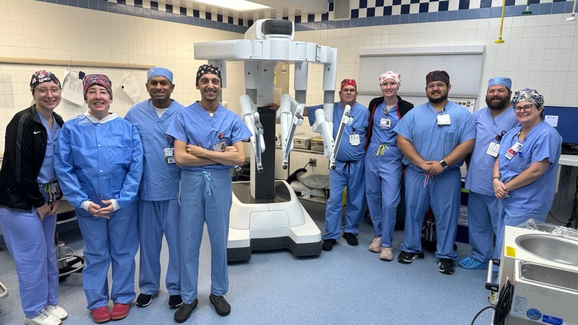 UC Health cardiac surgery team in the operating room around robotic system used during a heart surgery