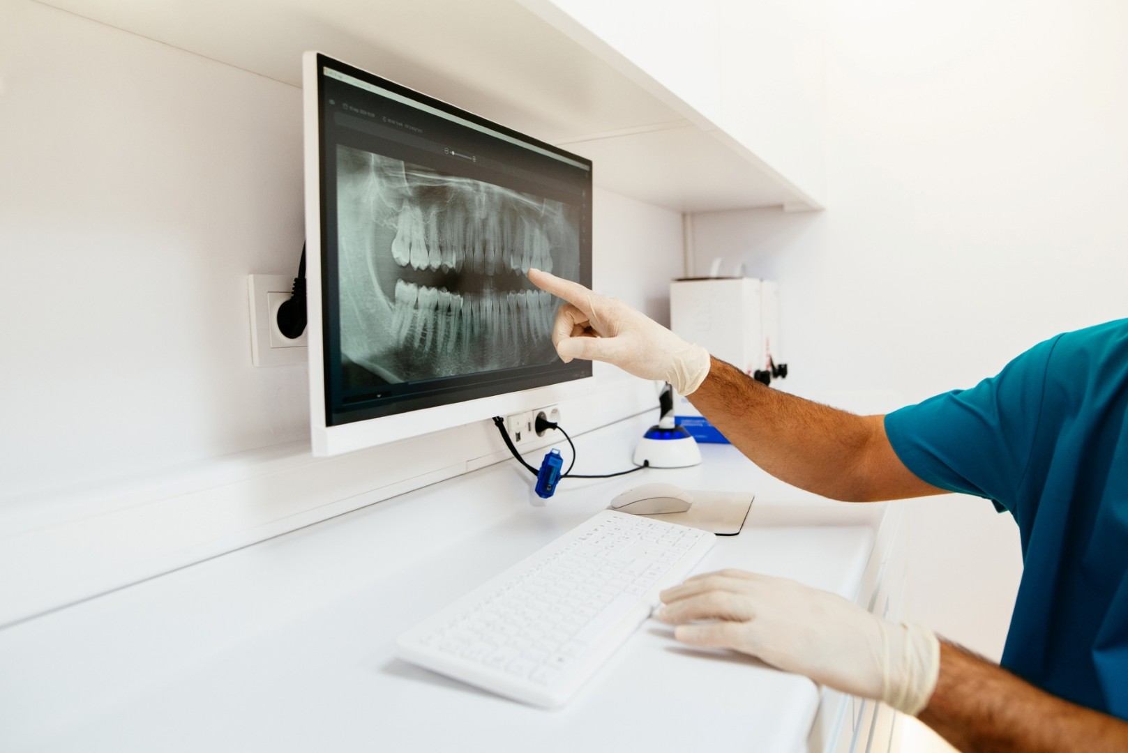 Patient and physician look at digital x-ray.