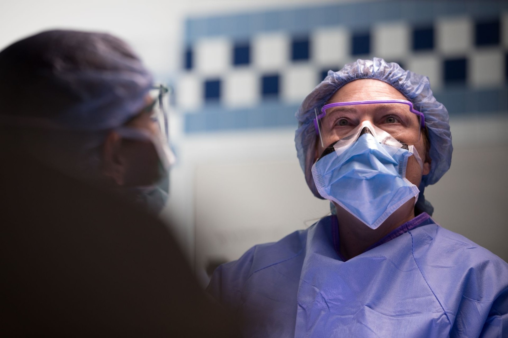 Dr. Starnes and physicians in masks and scrubs performing a medical procedure. 