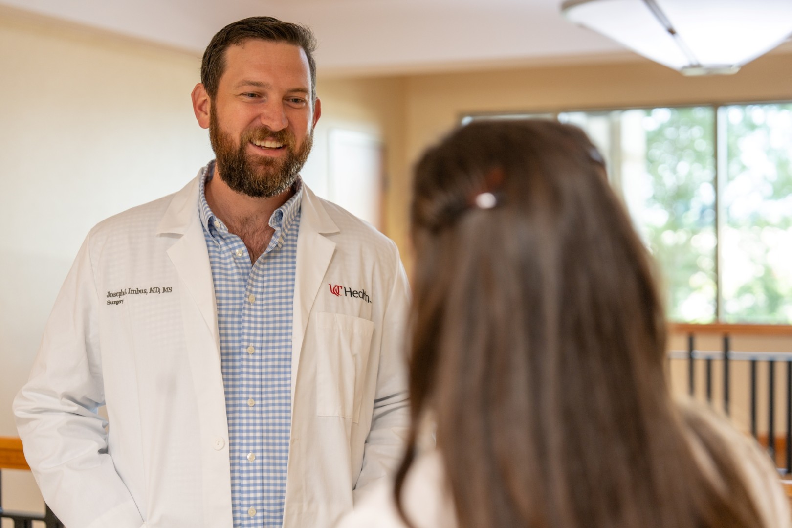 Physician talks with a patient in a medical setting. 