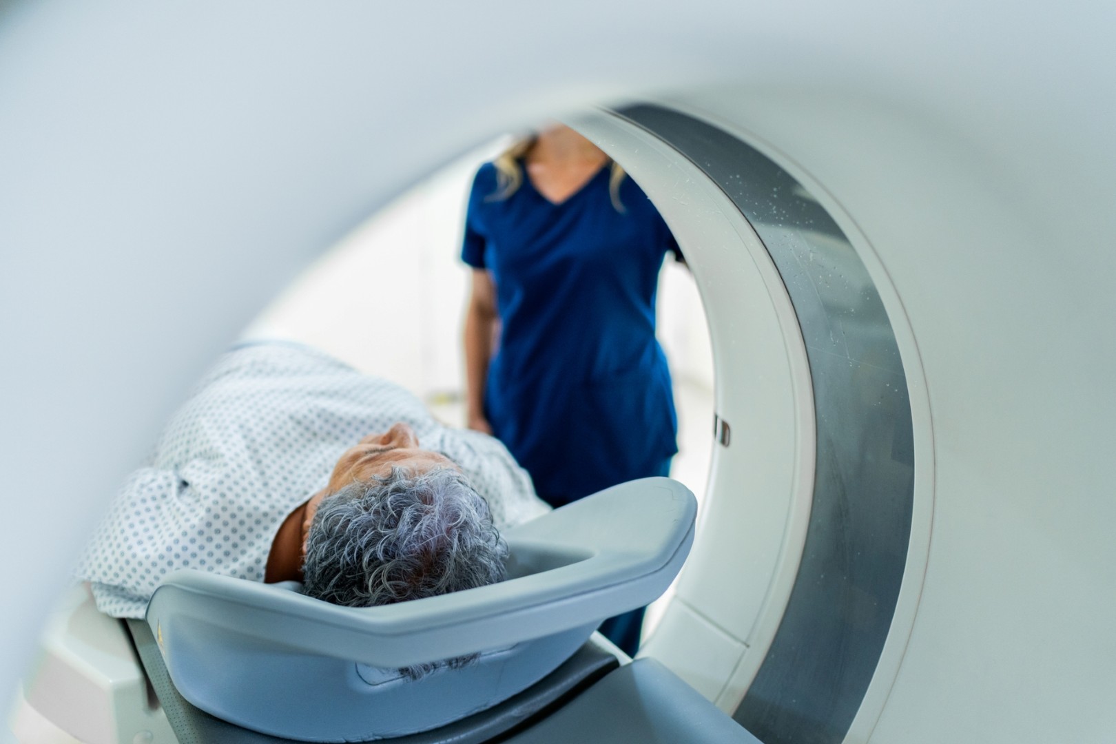 Medical provider attends to a patient in an MRI.