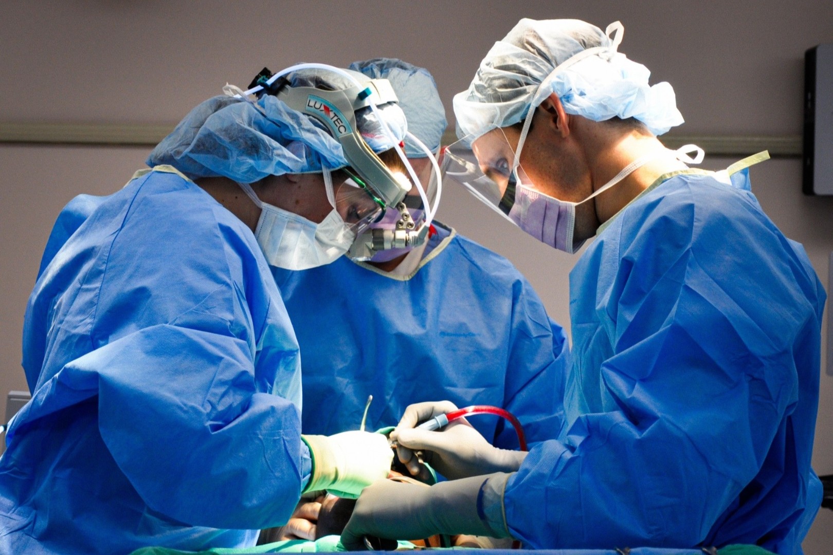 Physicians perform a medical procedure.