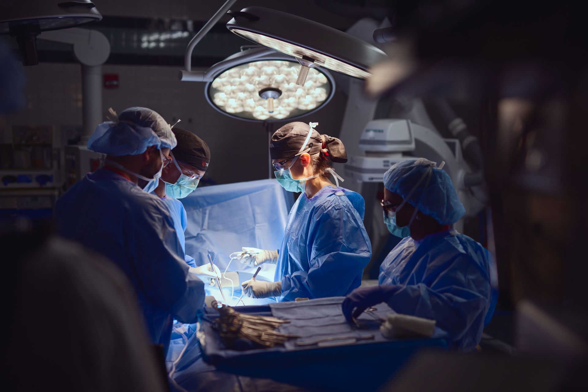 Physicians perform a surgical procedure.