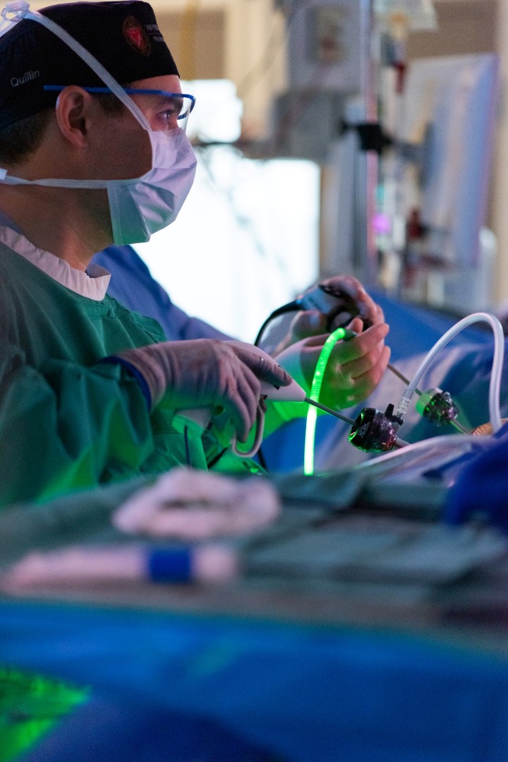 Surgeons perform a laparoscopic procedure.