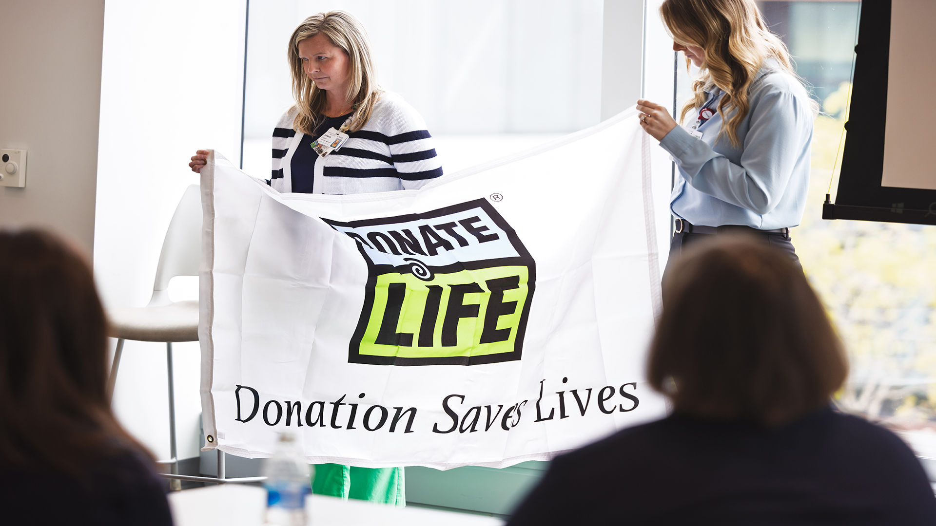 Transplant team members holding Donate Life flag