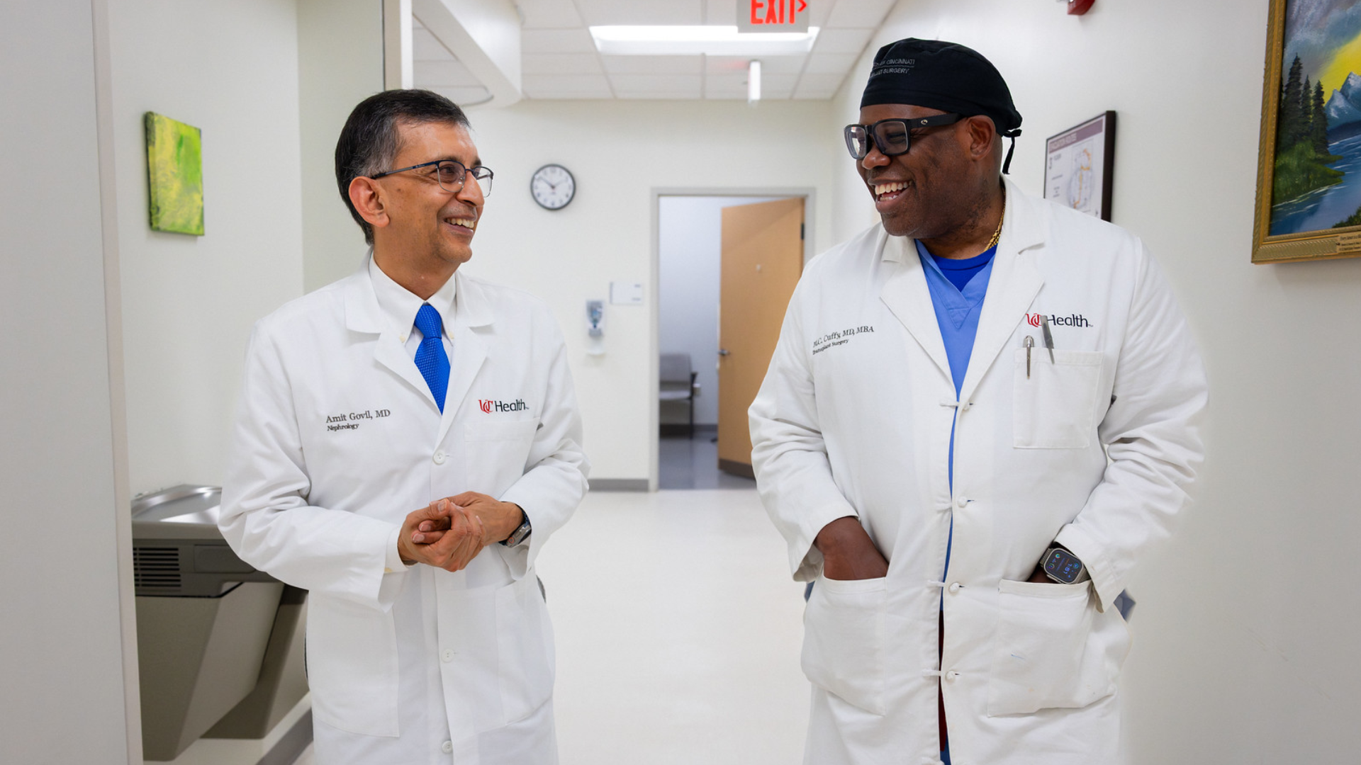 Dr. Govil and Dr. Cuffy walk down hallway