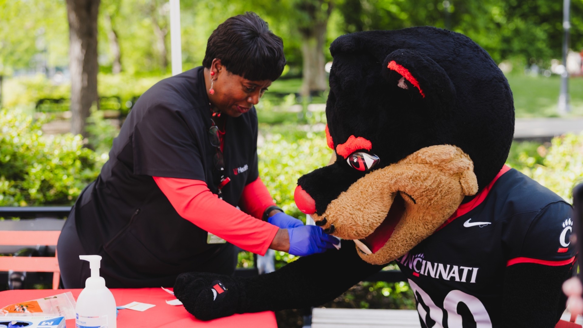 Community Members practice prevention education for 513 Day with the Cincinnati Bearcat at Washington Park.