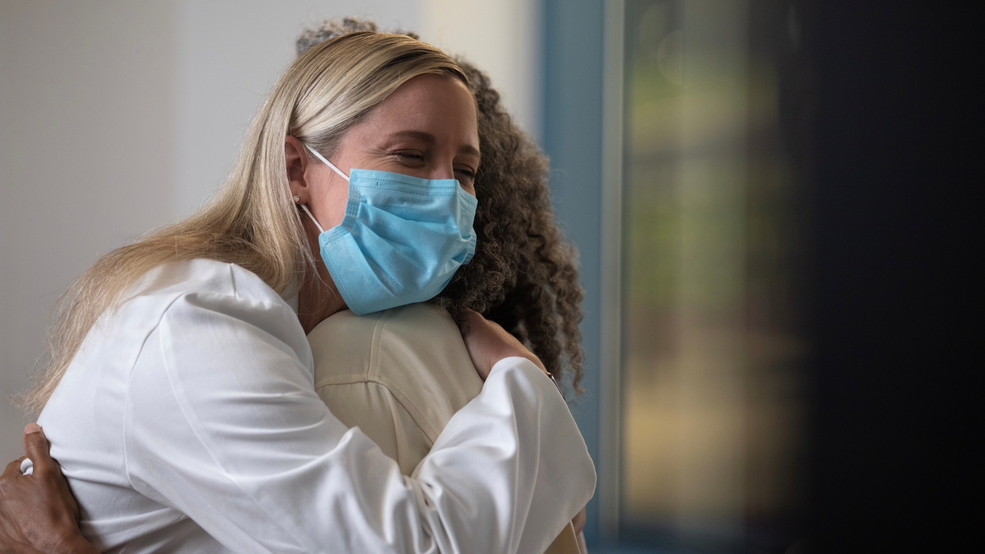 Physician hugs a patient. 