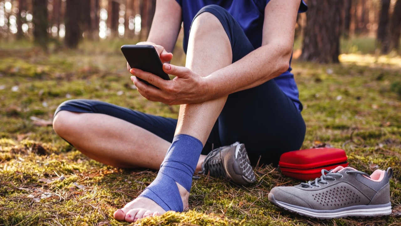 Injured woman on her phone downloading the TandemStide App.