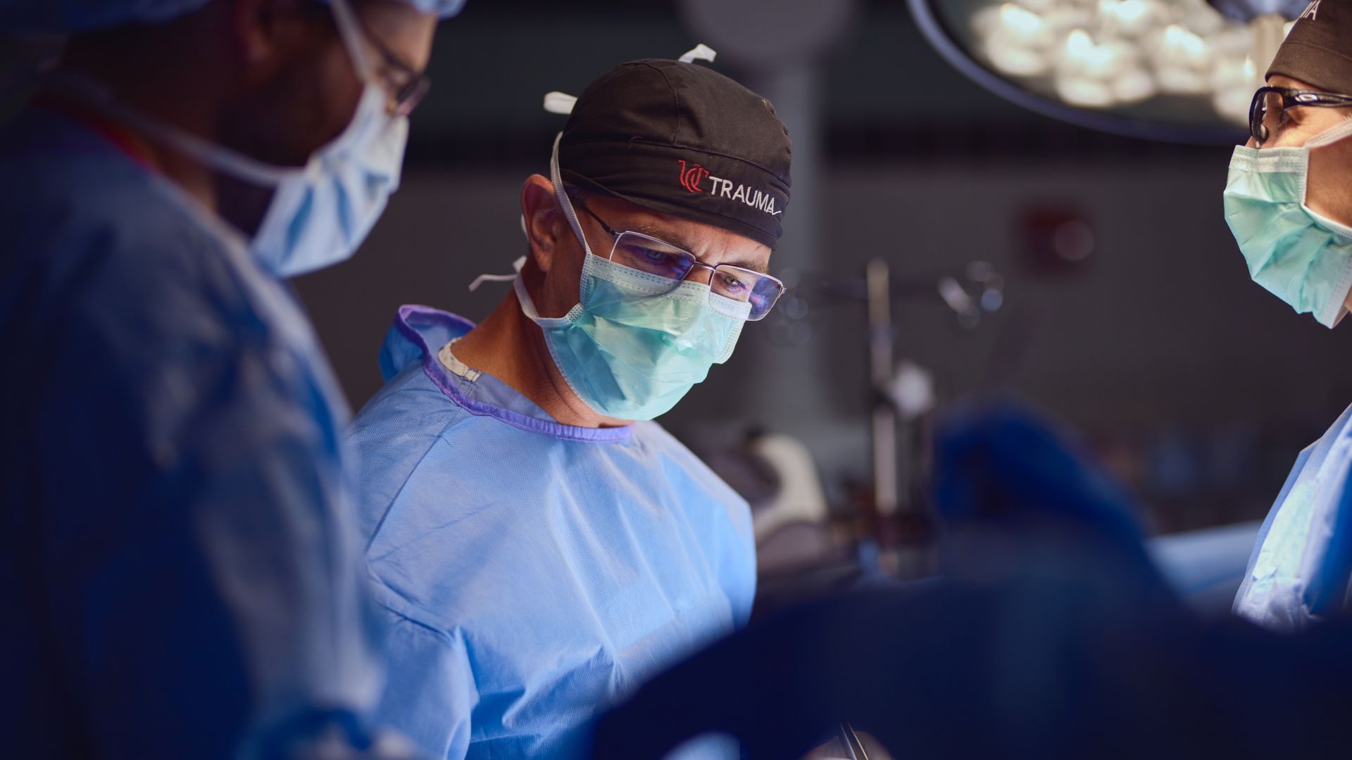 Doctor in scrubs preparing for a surgery in the UCMC Level I Trauma Center.
