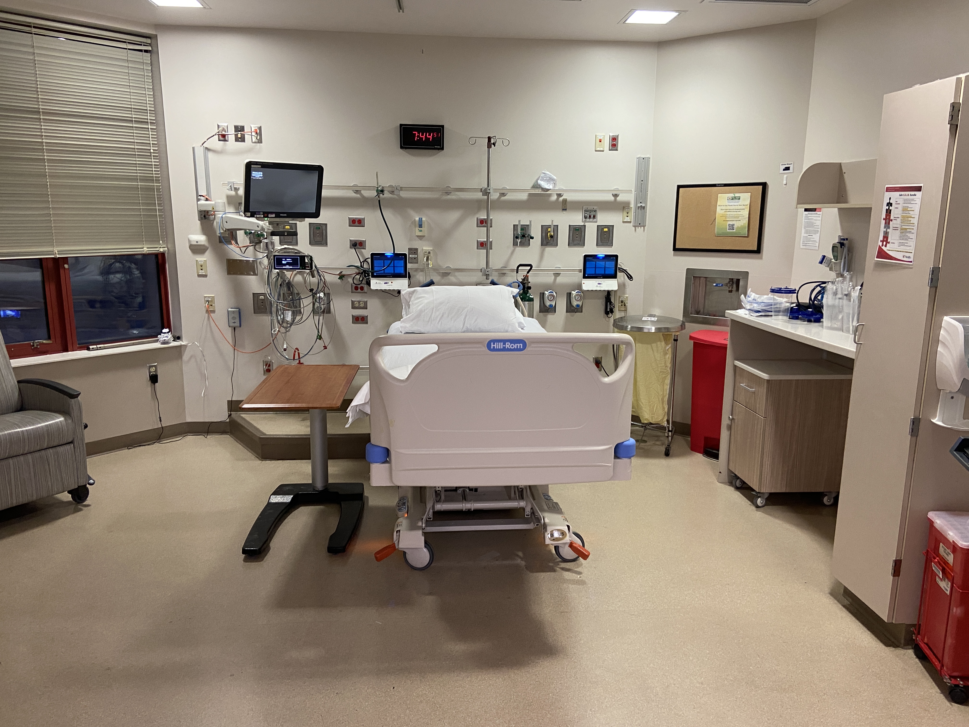 Physician in scrubs and masks perform surgery. 