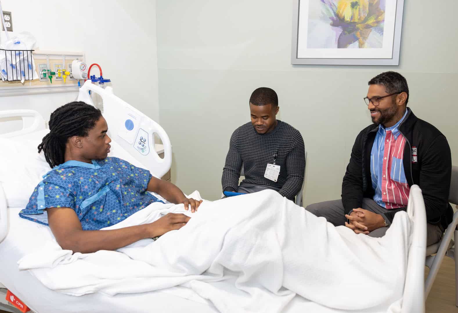 Violence Intervention Specialists meet with a patient impacted by gun violence.