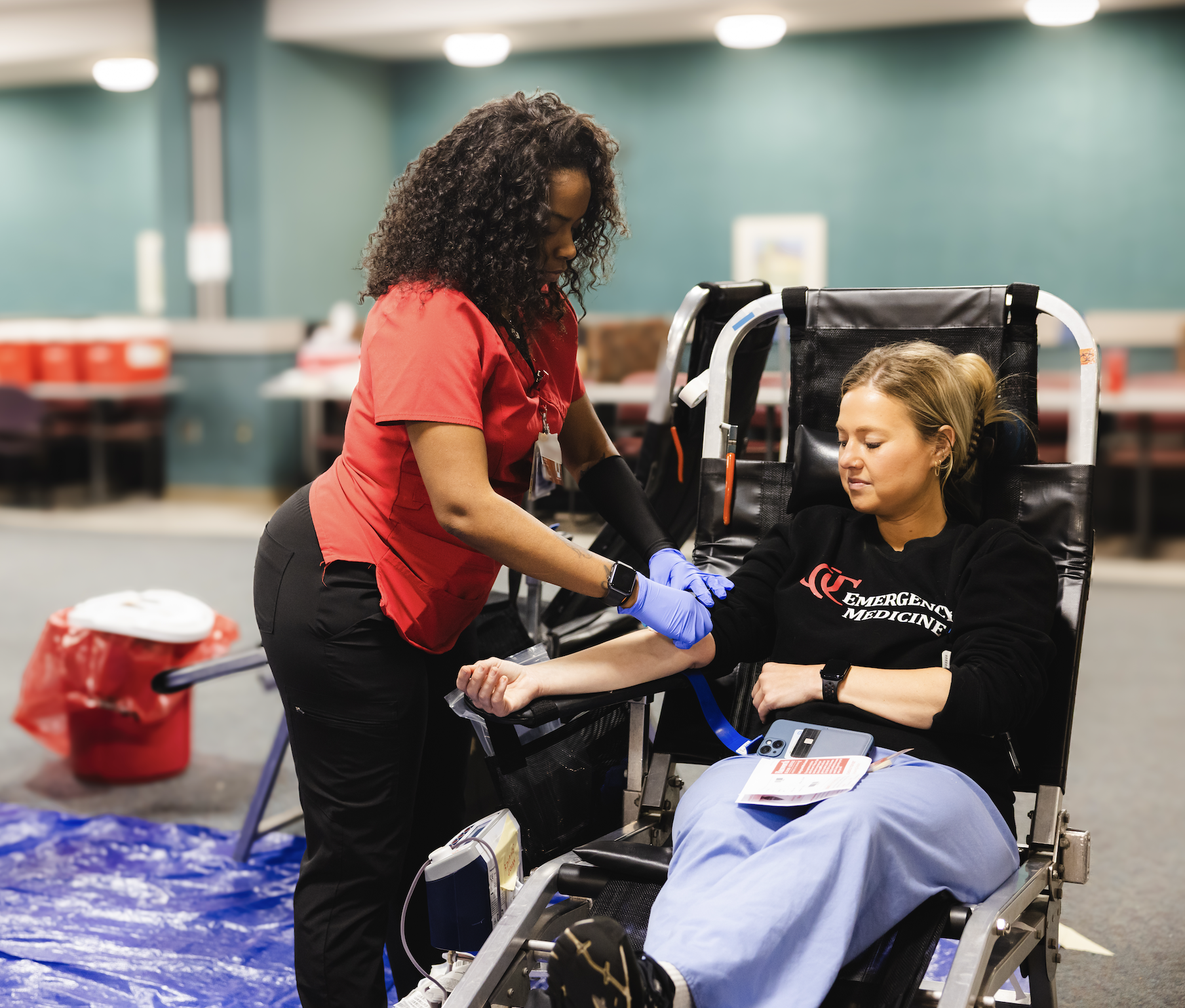 Emergency services team member donating blood at UCMC Blood Drive, 2025.