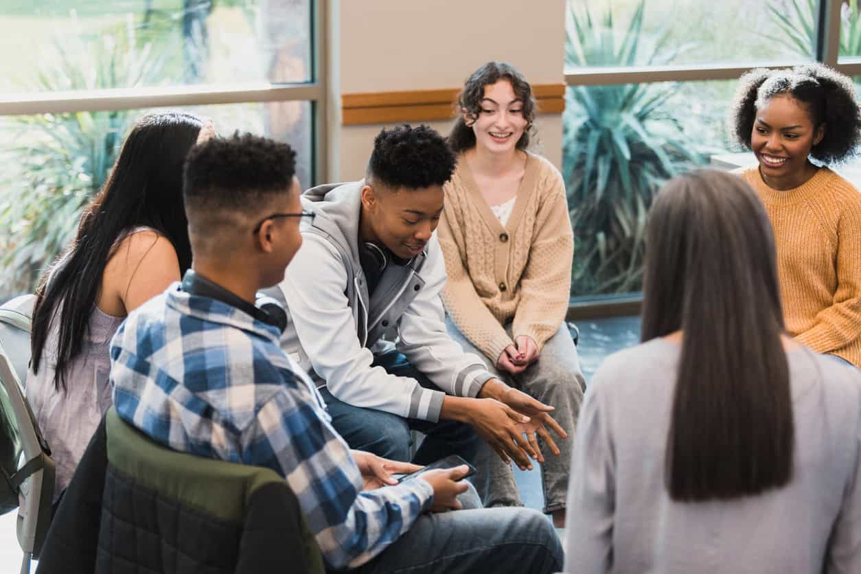 A group of teens in a support group setting.