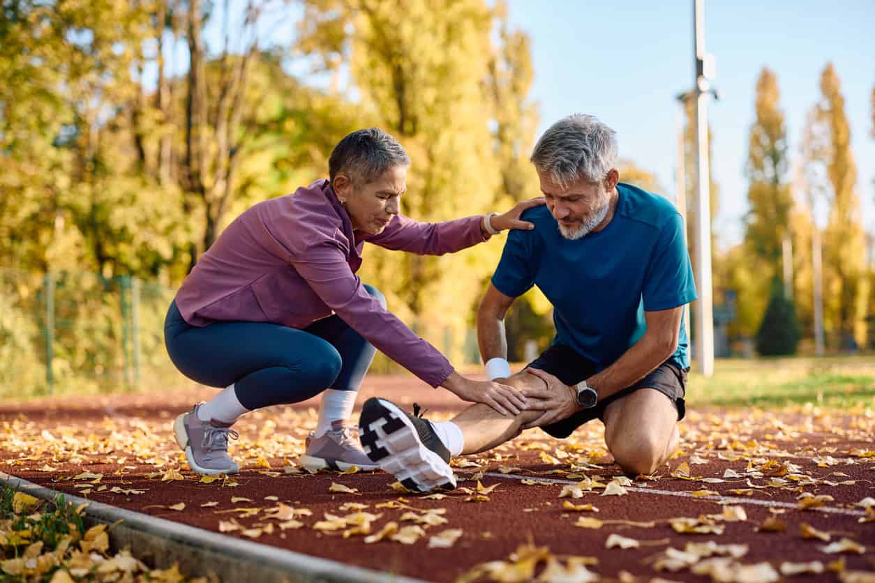 Two older adults stretching to prevent falls.