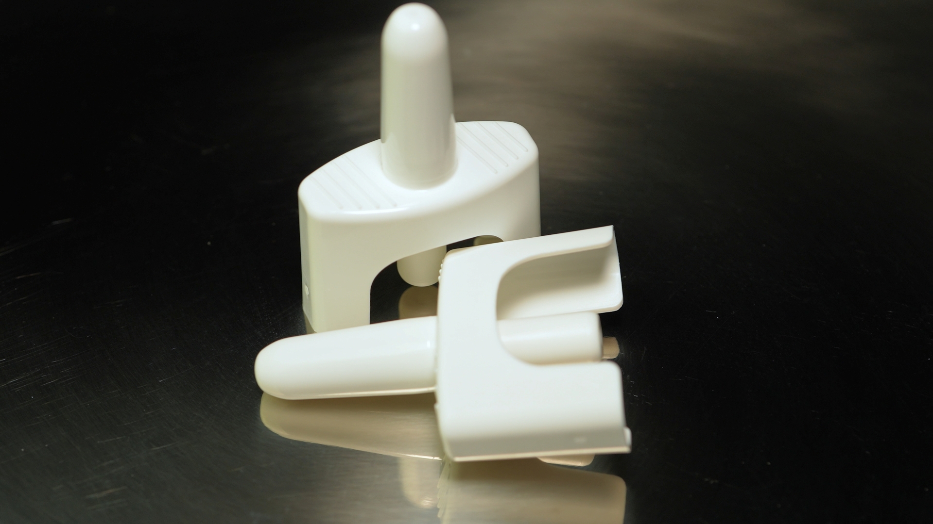 Nasal spray pieces on a metal table.