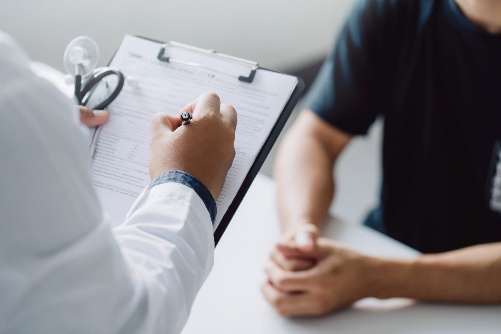 Physician has a consultation with a patient. 