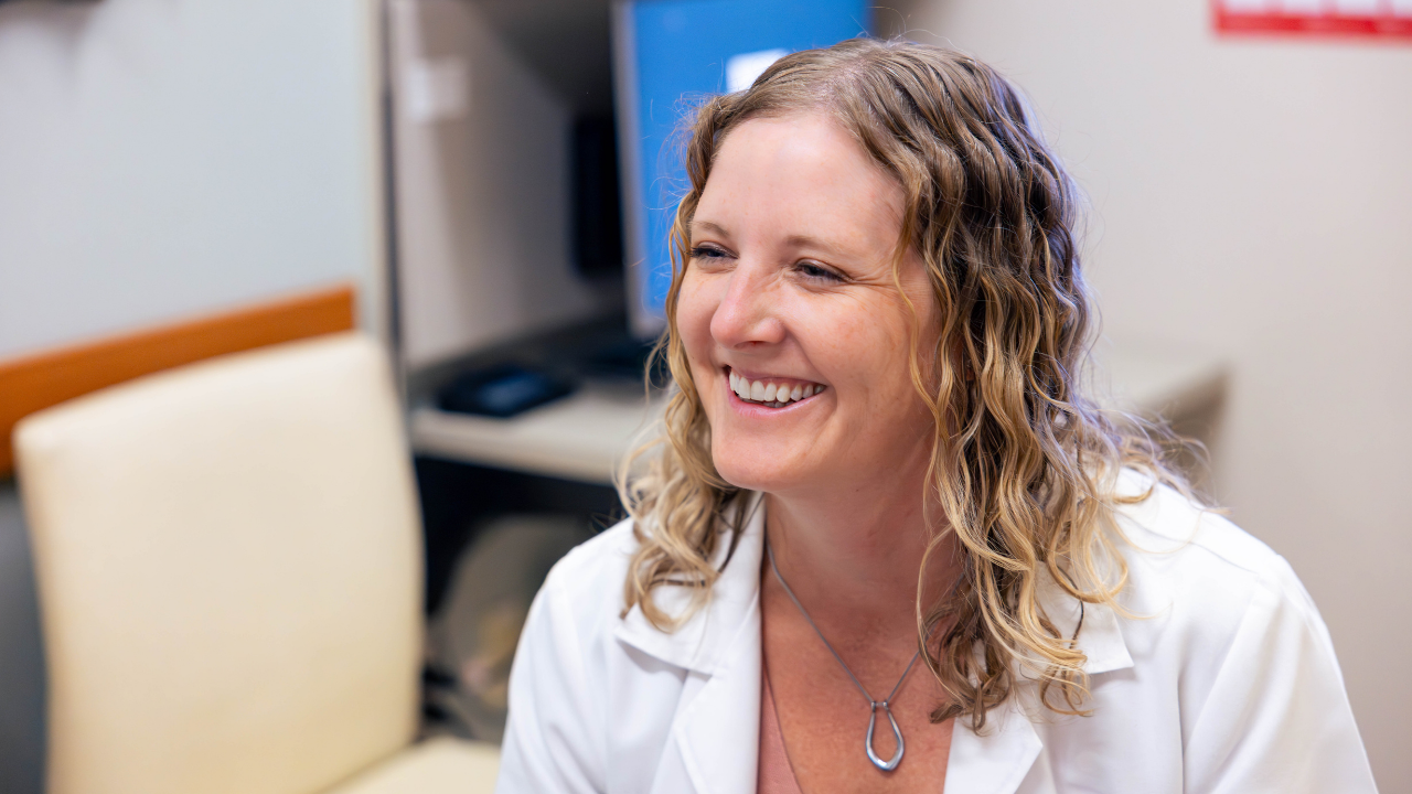 Physician smiles at patient. 