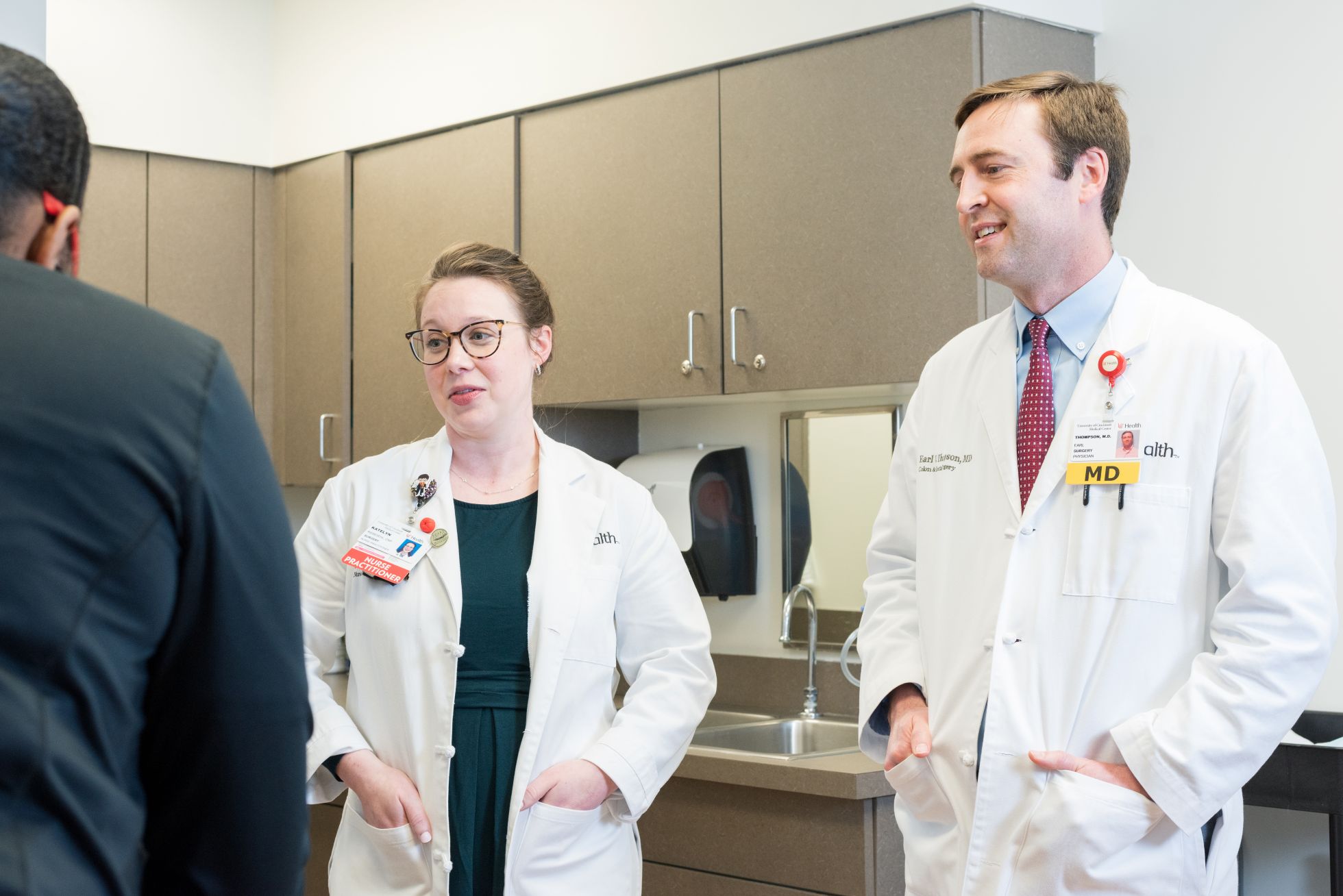 Physician attends to a patient in a medical setting. 