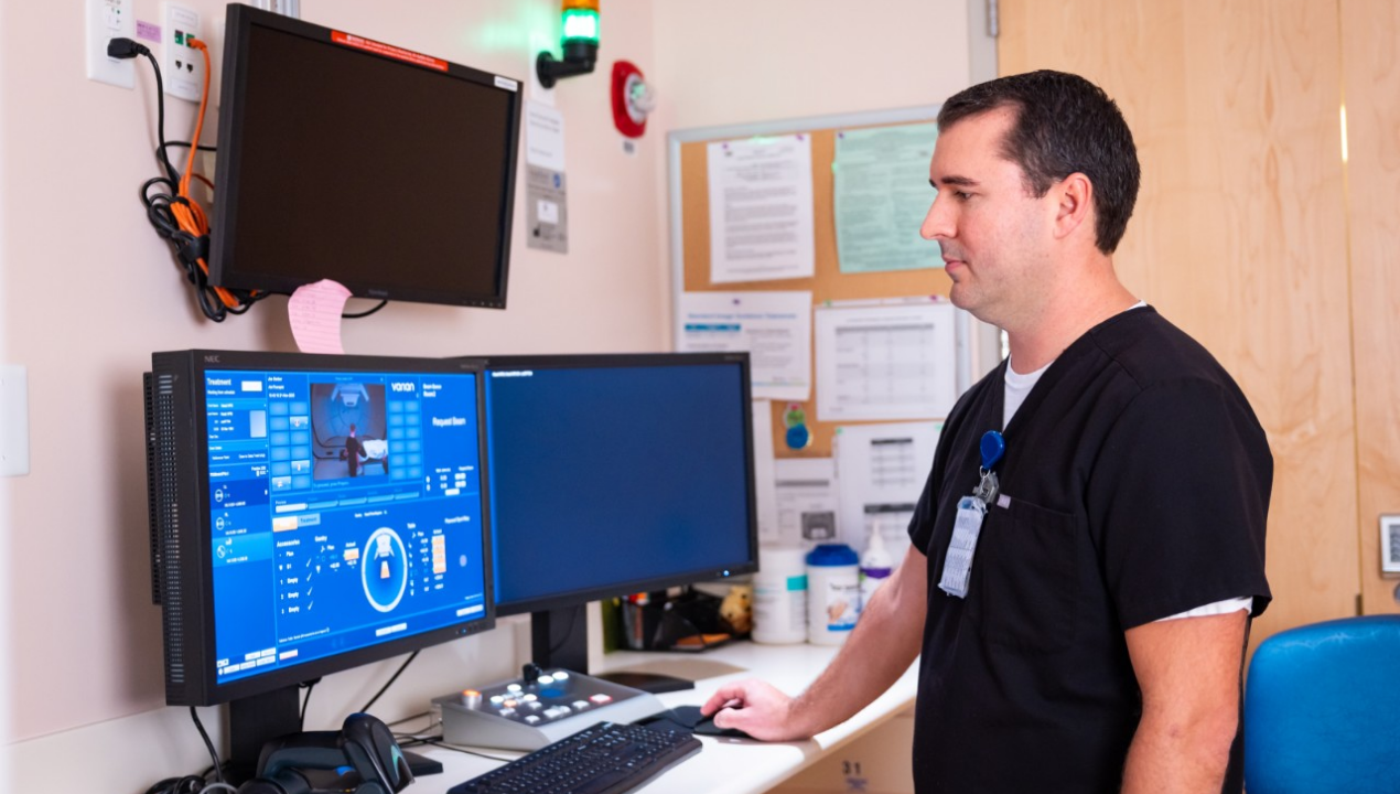 Technician at the Proton Therapy Center looks at a screen