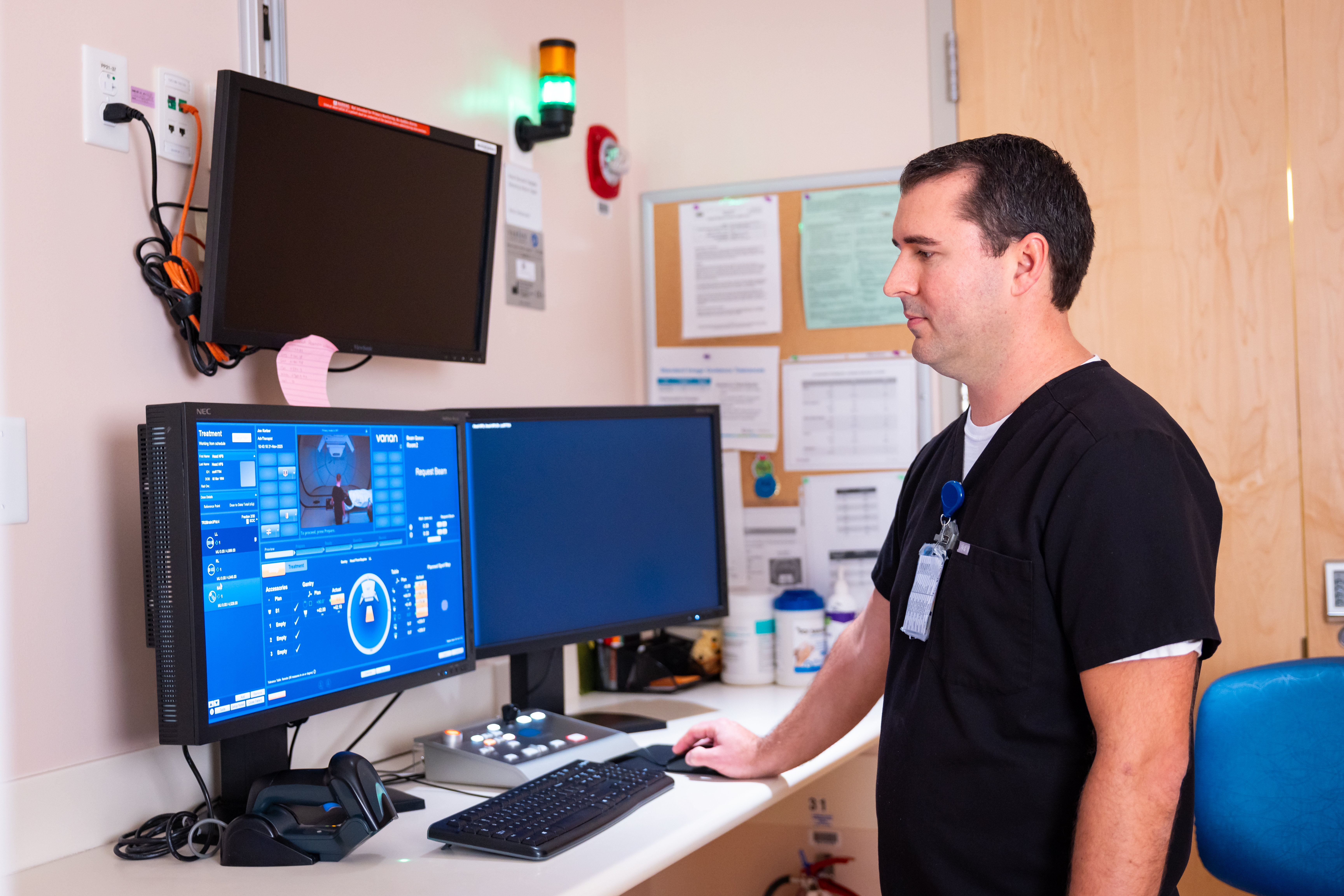 Technician  at computer during Proton Therapy session