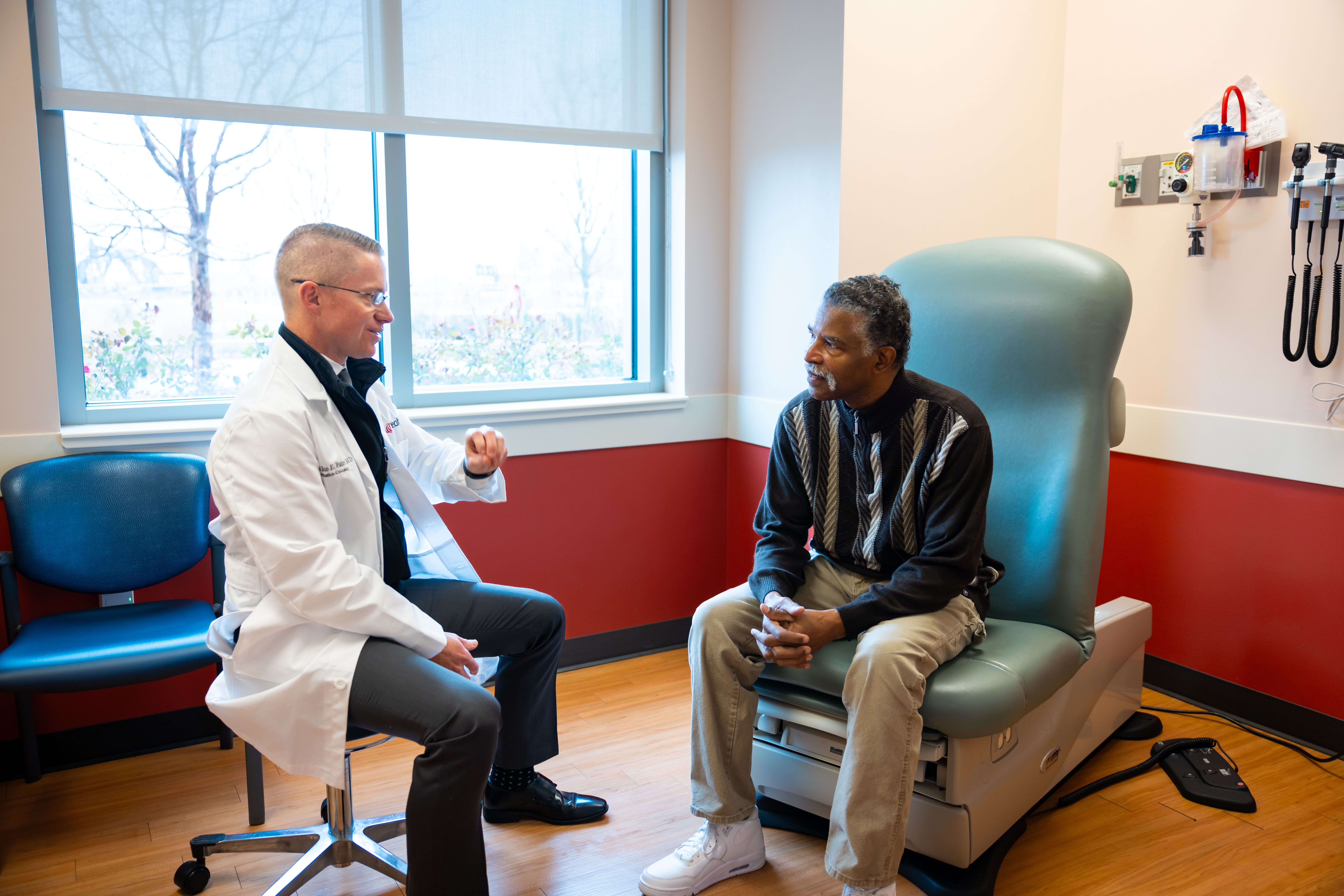 Physician at the UC Health Proton Center meeting with a patient