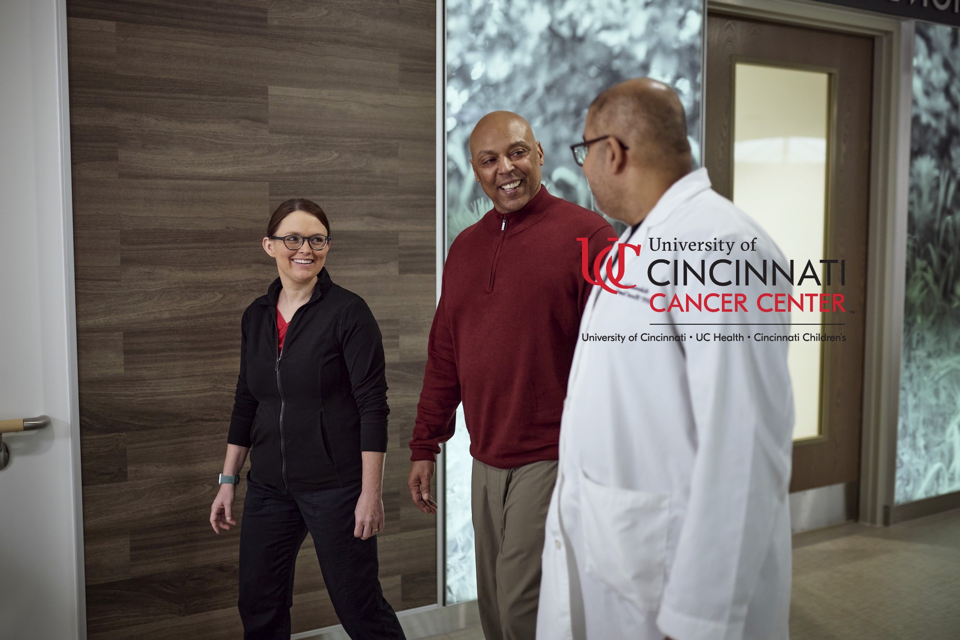 Physicians talk in a hallway. 