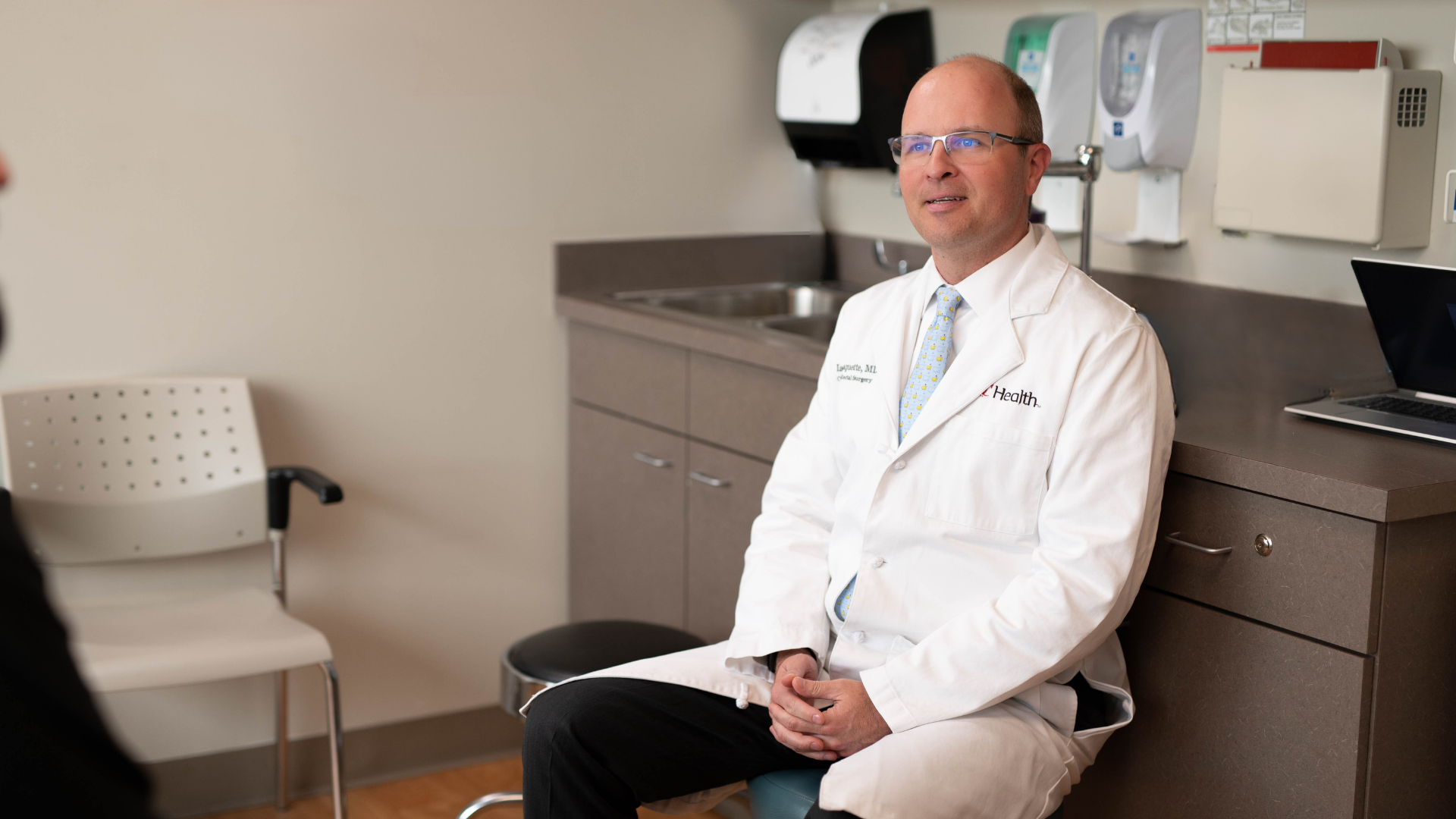 Dr. Paquette meets with patient in a medical office setting to discuss Colorectal surgery at UC Health