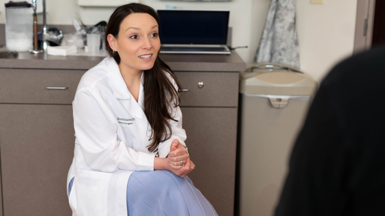 Physician at the University of Cincinnati Cancer Center's Young-Onset Colorectal Cancer Program speaks with a patient in an office setting