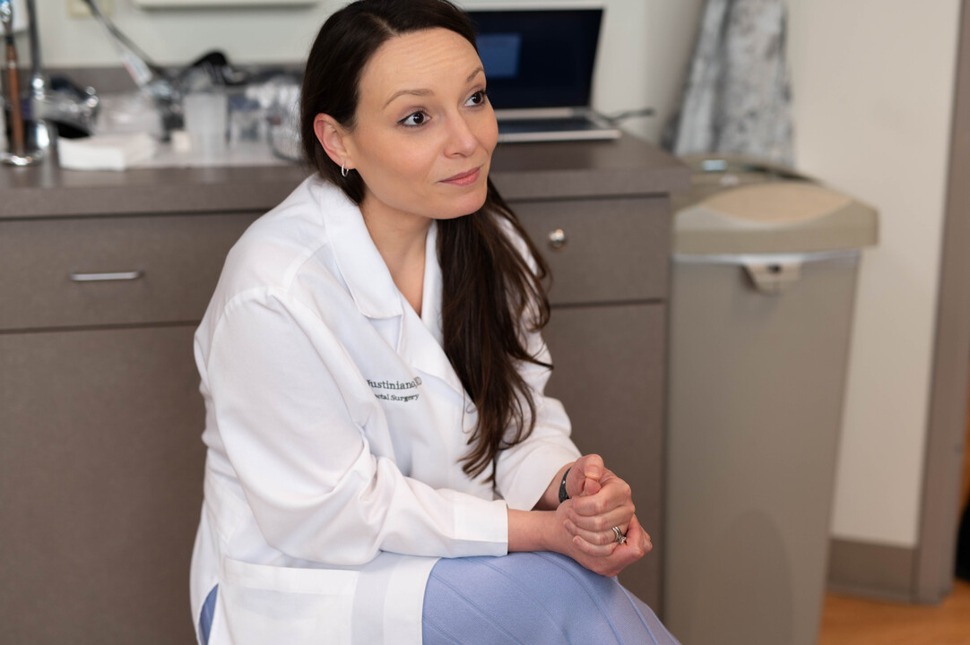 Physician meets with young patient in office during colorectal cancer appointment at UC Cancer Center.