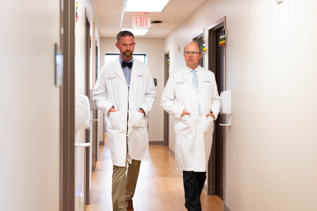 Colorectal Surgeon at the University of Cincinnati Cancer Center explains minimally invasive procedure to patient in office setting
