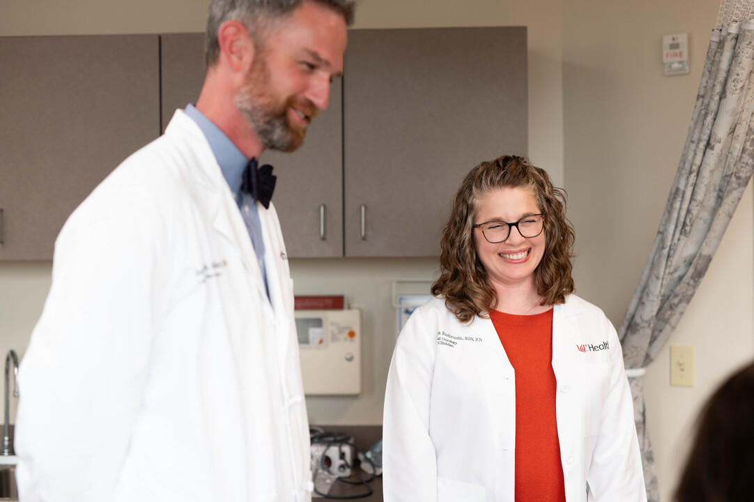 Physician talks with a patient in an exam room.