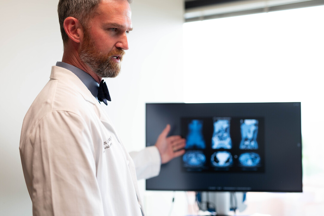 Physician at the University of Cincinnati Cancer Center references a patient's results to discuss treatment options for colorectal cancer