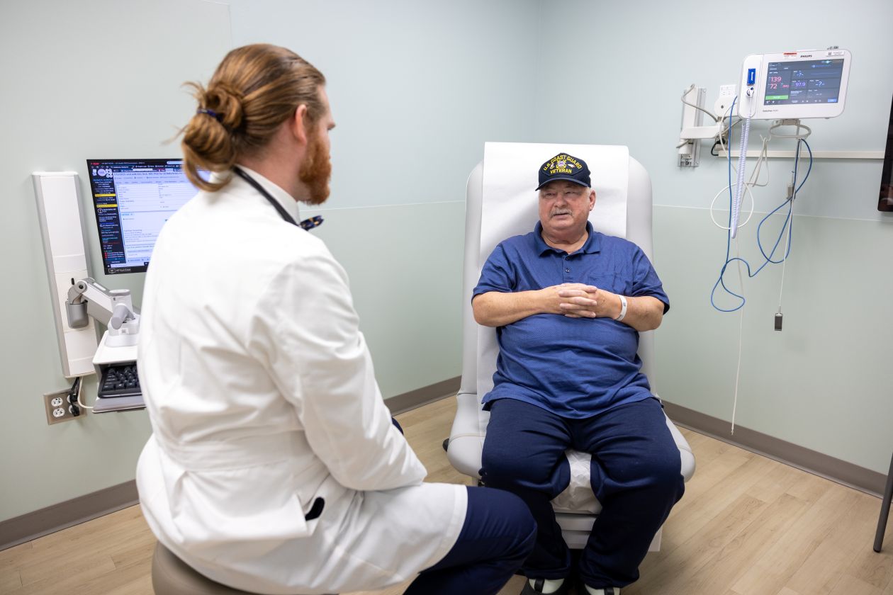 Physician talks with a patient in an examination room. 