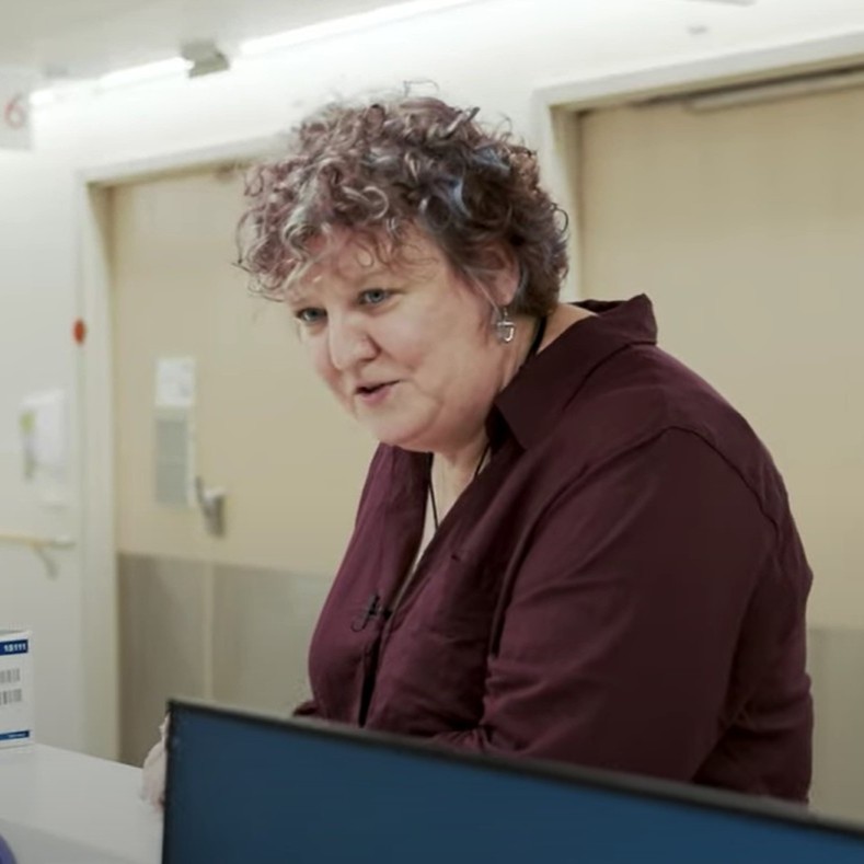 Chaplain talks with medical staff.