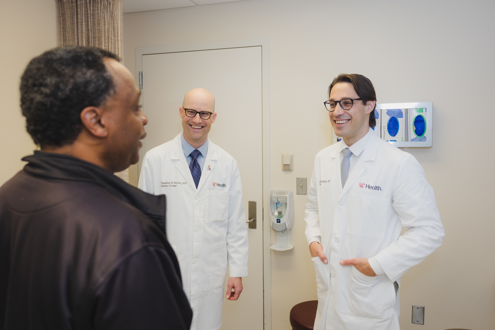 Physicians talk with a patient. 