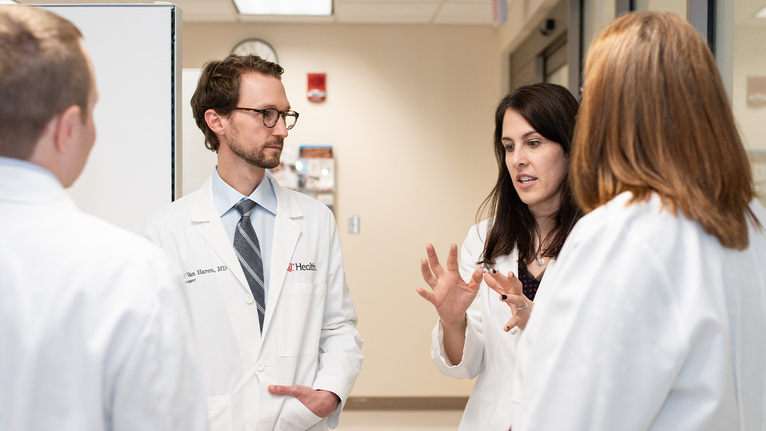 Group of physicians talking in a medical environment.