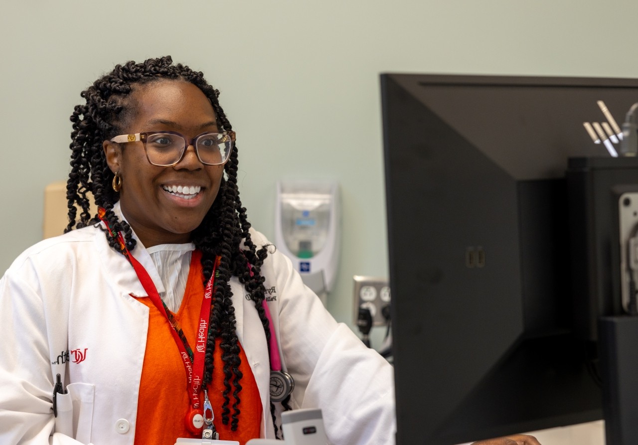 Medical provider looks at a computer screen. 